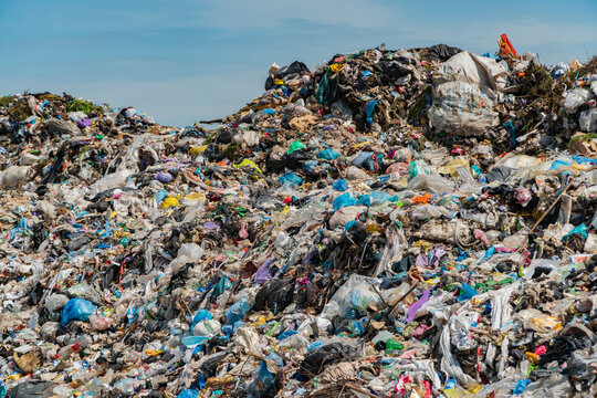 A large landfill site filled with natural and synthetic waste reflects the challenge of pollution and its effect on the environment