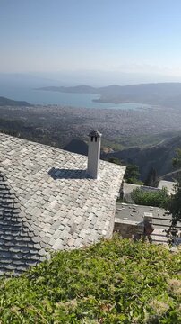 Beautiful panoramic view from the mountain village of Makrinitsa near Volos, Greece, overlooking the lush green hills and the shimmering blue waters of the Pagasitikos Gulf. Traditional Greek 