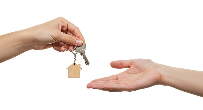 One hand offering house keys to another hand, symbolizing transfer of ownership.
