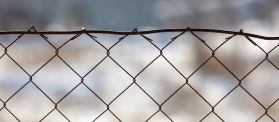A chain link fence with a wire on top