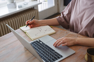 Creative entrepreneur sketching ceramic design in studio workspace