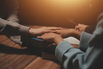 Christian group are praying to god with the bible and sharing the gospel. Concept of faith for god.