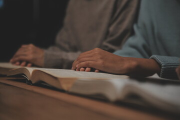 Christian group are praying to god with the bible and sharing the gospel. Concept of faith for god.