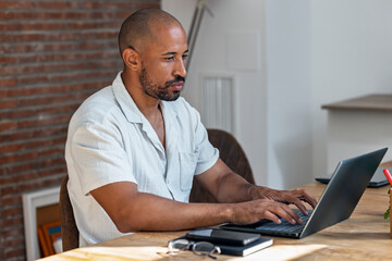 Trader working from home on laptop analyzing finance data