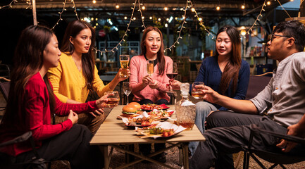 Group of Asians are having a celebration at a restaurant with drinks.	