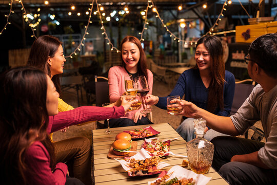 Group of Asians are having a celebration at a restaurant with drinks.	