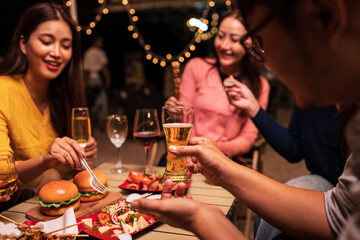 young couple celebrating with champagne at night