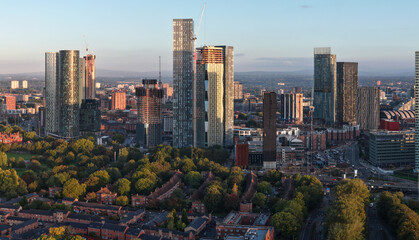 Aerial sunrise view of Deansgate Square high-rises and Hulme residential area in Manchester. © bardhok
