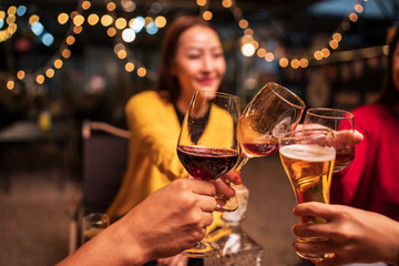 Group of Asians are having a celebration at a restaurant with drinks.	