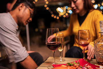 Group of Asians are having a celebration at a restaurant with drinks.	