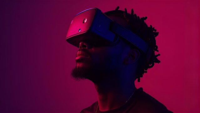 A man immersed in augmented or virtual reality, illuminated by intense pink and yellow ambient light sources.