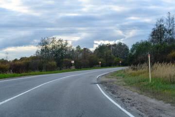 Asphalt country road curve in autumn landscape, turn.