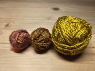 Colorful yarn balls on wooden background