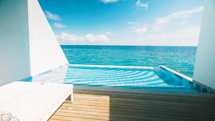 Fototapeta premium Private deck water villa with infinity pool overlooking the vast, bright blue Indian Ocean