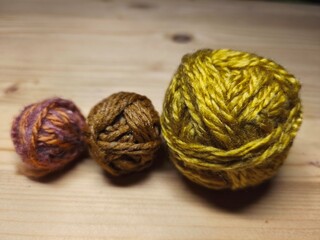 Colorful yarn balls on wooden background