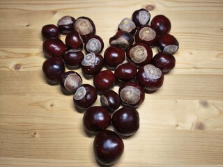 Chestnuts Arranged in Heart Shape on Wooden Table