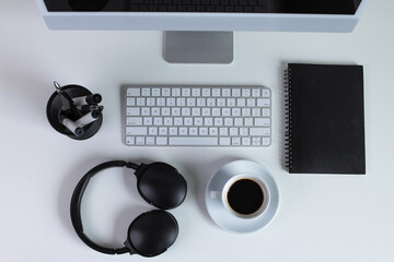 Top View Of Computer, Coffee, Notebook, And Headphones On Office Desk