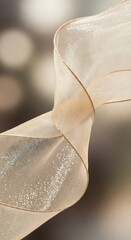 Luxurious sheer ribbon with delicate golden trim, swirling gracefully