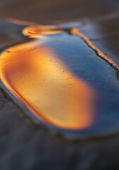 Iridescent puddle reflection evoking warmth and depth on a textured surface shimmering dreamlike