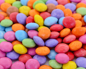 Pile of colorful candy coated chocolates close up
