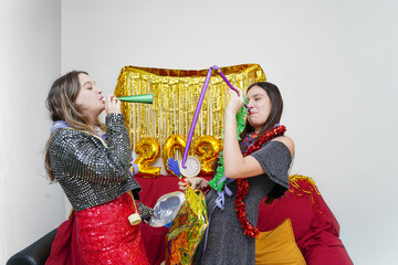 Two friends dancing at New Year's Eve party