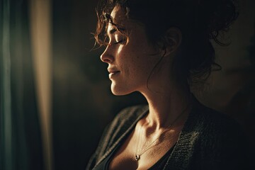 Photo of an unknown pregnant woman meditating at home. Side view. Bokeh.