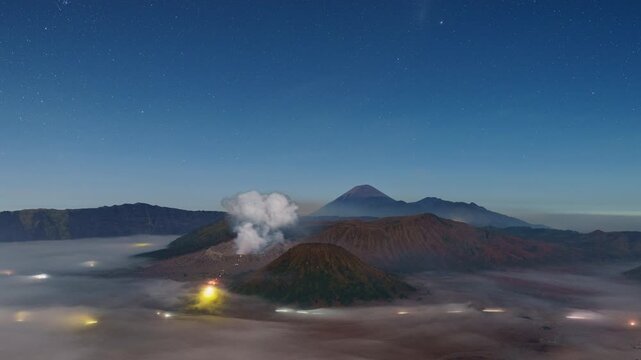 Timelapse stars to sunrise Bromo volcano with sea of mist, East Java, Indonesia 
