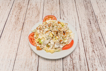 Classic Cobb salad with grilled chicken strips, avocado wedges, chopped hard-boiled egg, crispy bacon, and crumbled blue cheese on lettuce