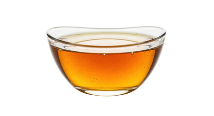 Isolated glass bowl filled with organic honey ready to serve a healthy dose of sweetness