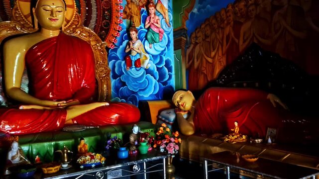 Intricately decorated Buddhist temple interior with monks and colorful wall paintings, sacred statues