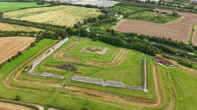 Orbiting aerial view of the historic Richborough Roman Fort ruins in Kent, England