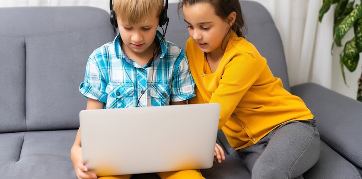 Cute kids friends using laptop