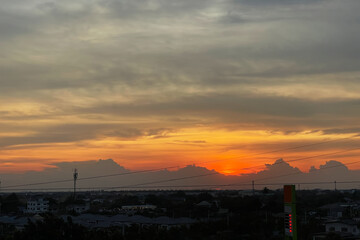 Aerial view show dramatic twilight sky atmosphere with sunset in tropical summer season on suburb area of Bangkok, Thailand. Image use for tourism and meteorology presentation backdrop.