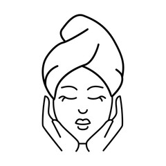 A serene woman with her eyes closed and a contented smile wrapped in a towel on her head looking refreshed
