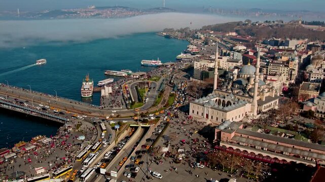 Aerial panorama of Istanbul&rsquo;s historic peninsula showing Yeni Mosque, Topkapi Palace, and Hagia Sophia surrounded by morning fog over the Bosphorus &mdash; a stunning view of timeless beauty.