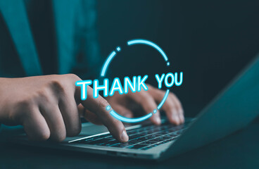 Businessman typing on laptop with glowing digital thank you text on screen, symbolizing communication, appreciation, online marketing, and modern business technology connection.