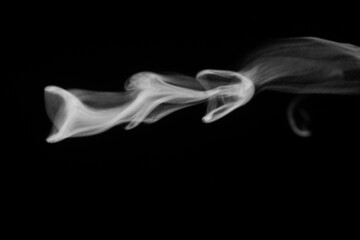 Close-up view of white water vapor with spray from the humidifier. Isolated on black background. steam smoke on black background. White fantasy smoke