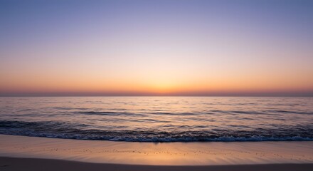 Obraz premium Experience the tranquility of a serene sunrise over the calming ocean waves, with soft pastel colors creating a peaceful and reflective atmosphere on the sandy beach