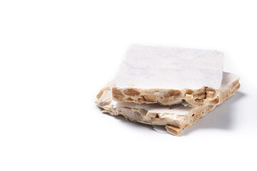 Delicious almond nougat isolated on white background. Traditional Christmas sweet. Copy space
