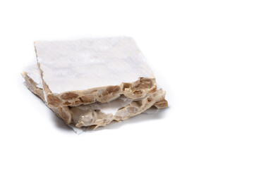 Delicious almond nougat isolated on white background. Traditional Christmas sweet. Copy space