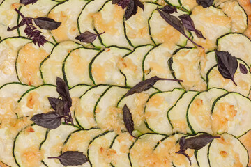 Surface of cooked zucchini pizza on baking sheet, top view