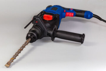 Electric rotary hammer with inserted long drill bit close-up