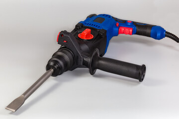 Electric rotary hammer drill with inserted flat chisel close-up