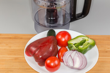 Different vegetables against processing work bowl of food processor