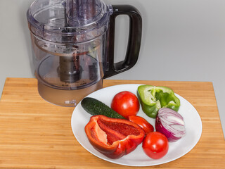 Different vegetables against processing work bowl of food processor