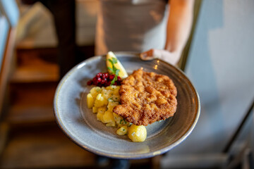 Stockholm, Sweden A plate of fried and breaded veal schnitzel with potato salad.