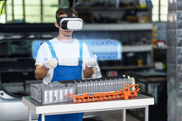 Serviceman using VR headset for electric car battery diagnostics in workshop