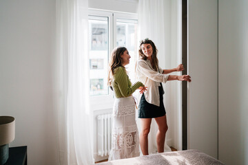Couple consulting about real estate in bright bedroom during home visit