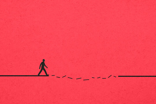 Man walking along a broken line illustrating difficulty and solitude