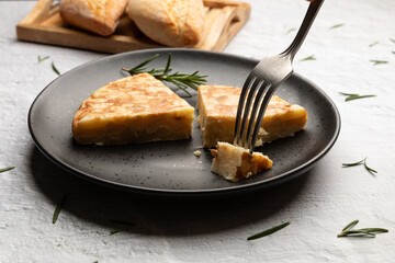Spanish potato omelette tortilla served on black dish 